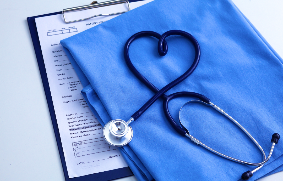 Stethoscope a shaped like a heart on medical scrubs and form