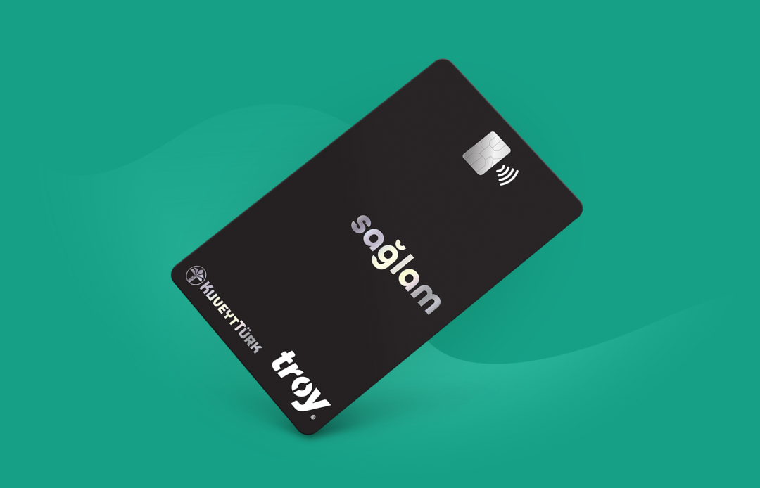 Black Kuveyt Turk Sağlam contactless credit card on green background