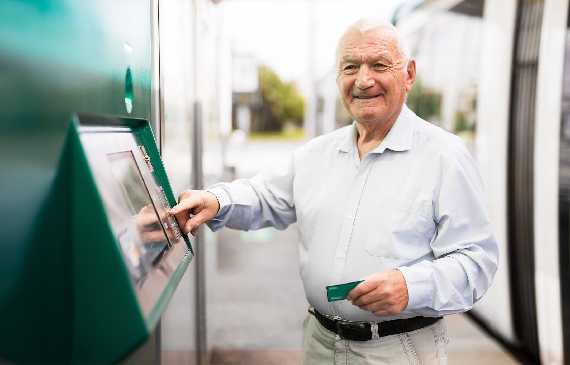 retired uncle withdrawing his salary from ATM