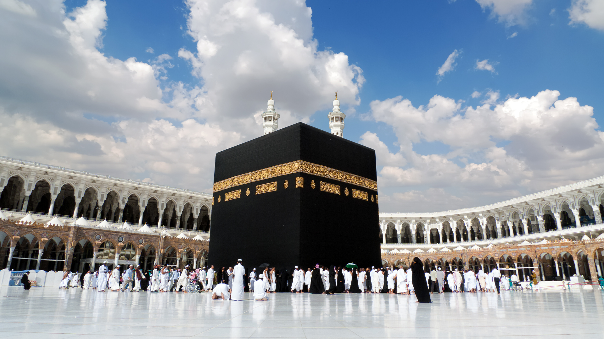 The Kaaba on a bright day with people performing the tawaf