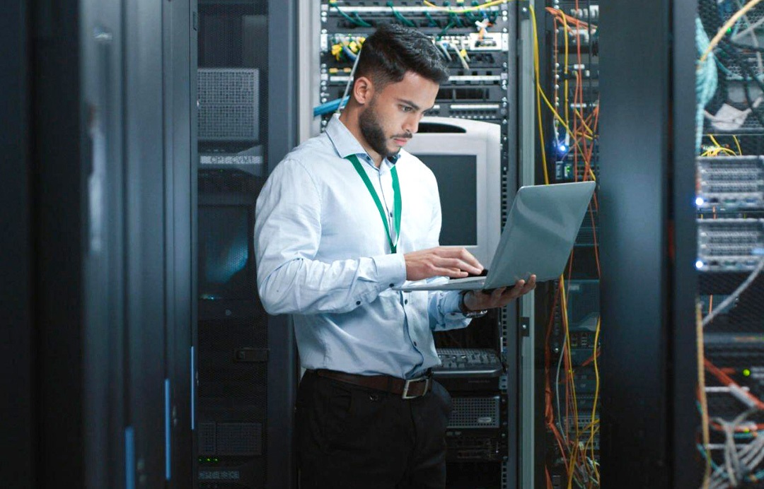 A man working at a computer for planned downtime