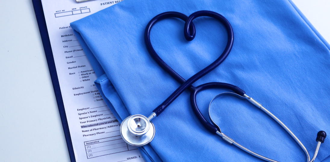 Stethoscope a shaped like a heart on medical scrubs and form