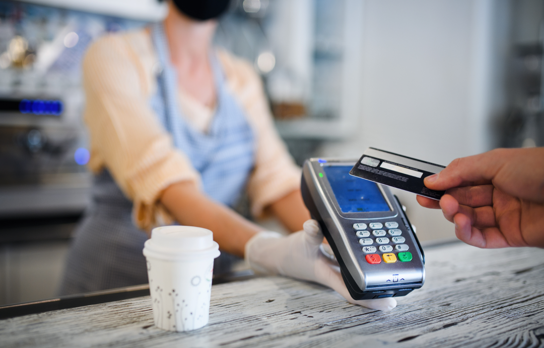 Customer paying with card a POS terminal in a cafe