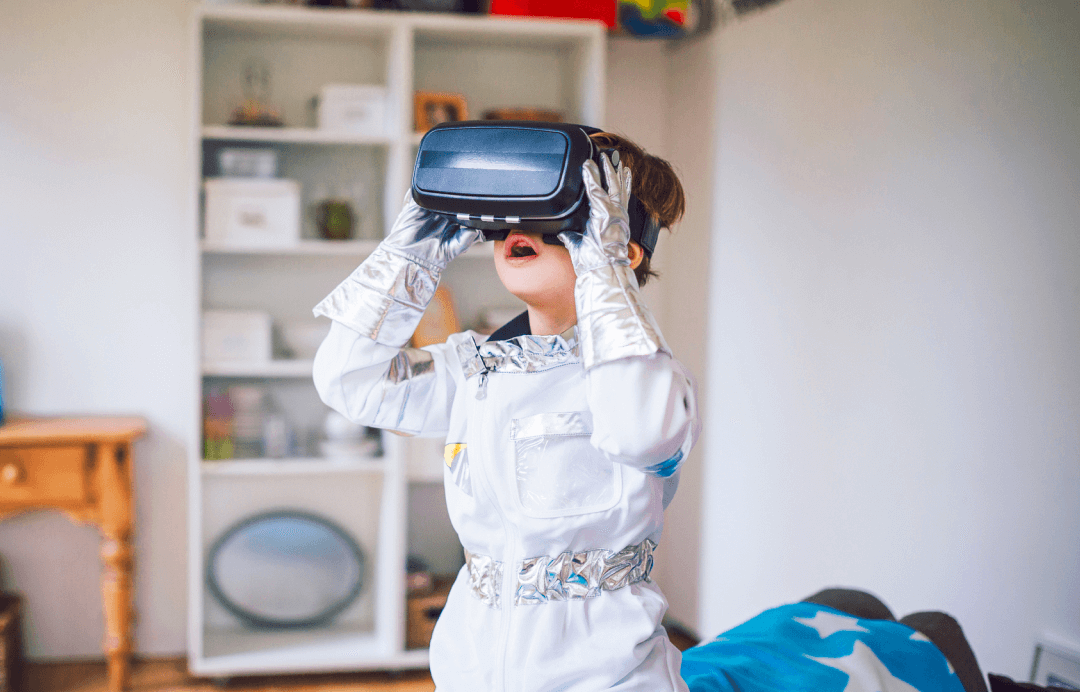 A child wearing a virtual reality headset and an astronaut costume