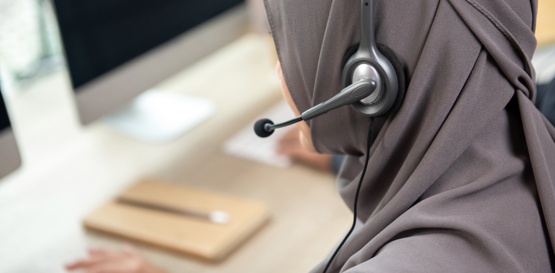 someone who works at a computer with headphones on Customer Satisfaction Center