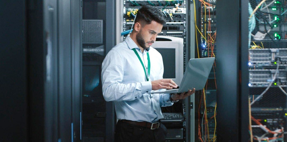 A man working at a computer for planned downtime
